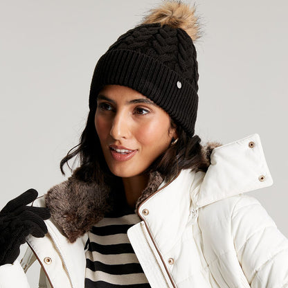 Gorro con pompón Elena punto de cable Pompón de piel sintética de Joules - Negro